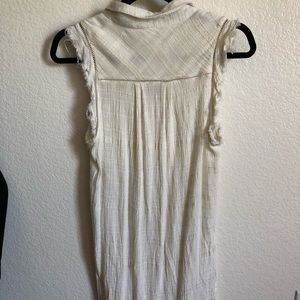 Long white sleeveless button down blouse
